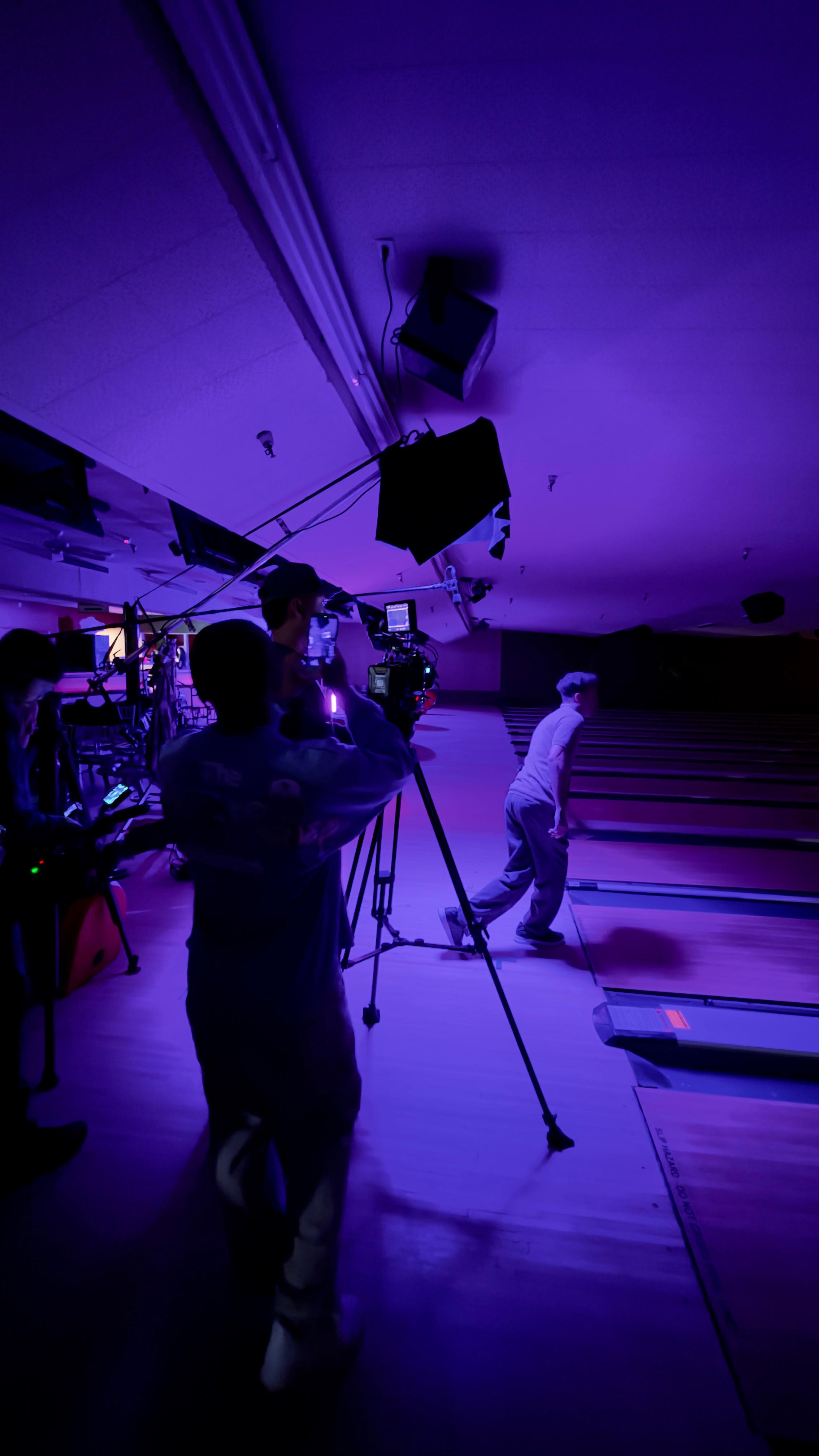 Camera operator filming talent at bowling alley - Downtown LA indie filmmakers